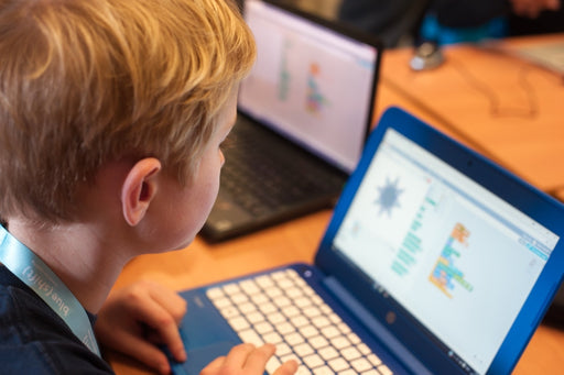 Boy using Scratch on laptop computer