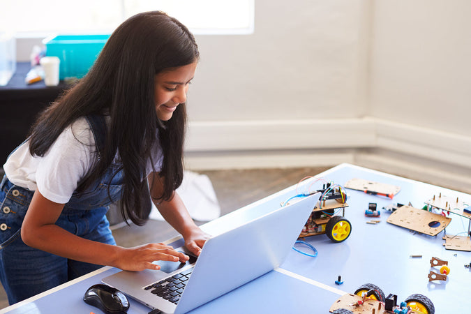 After school coding club - Female Student Building And Programing Robot Vehicle
