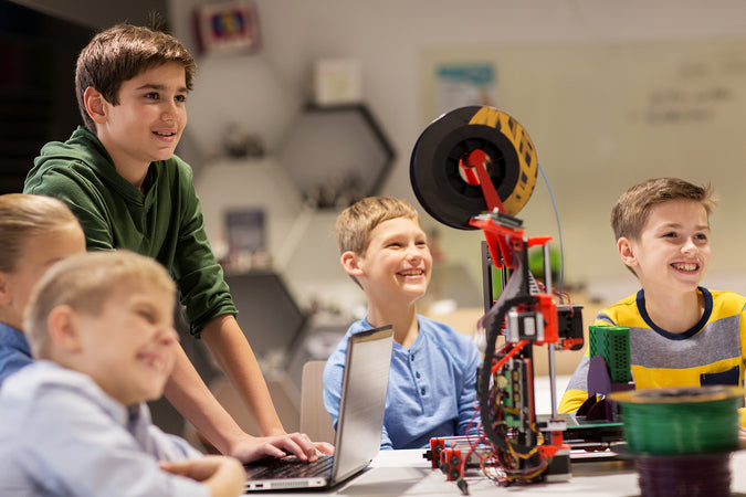 coding camp for kids - group of happy kids with 3d printer and laptop computer at robotics school lesson