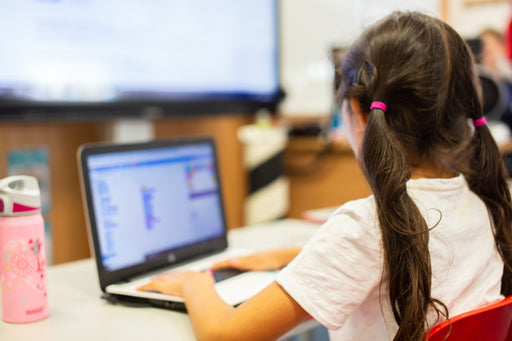 Girl learning Scratch on laptop computer