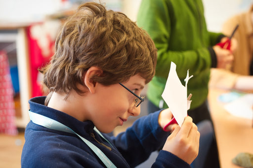 Boy cutting out paper shapes