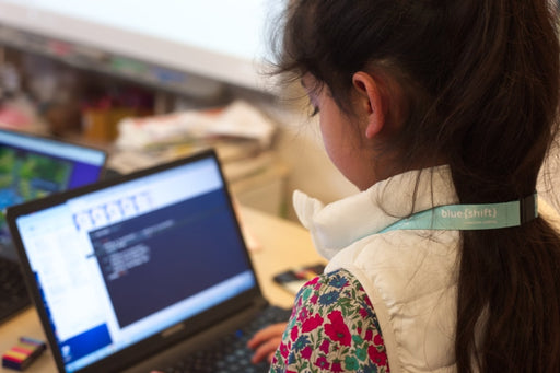 Girl learning to code on laptop computer